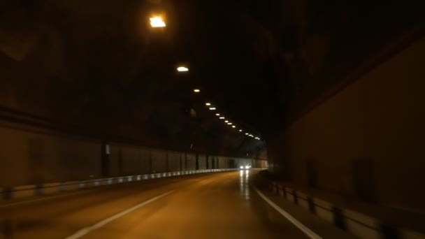 Sikt fra en bil i bevegelse, under bakken i en høyhastighetstunnel – stockvideo