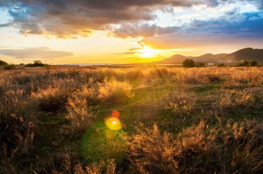 Yoğun gün batımı, gökyüzünü kaplayan devasa bulutlar.
