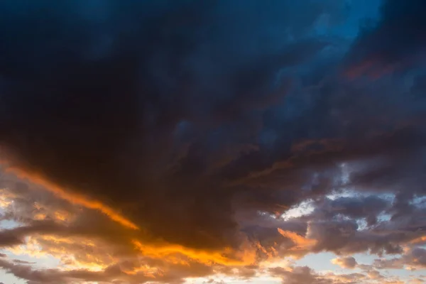 Storm clouds at sunset in orange and blue colors — Stock Photo, Image