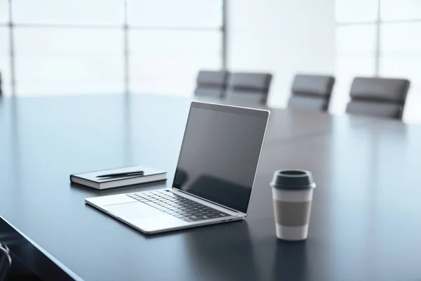 Modern laptop with cup of coffee on black table in conference room. 3D Rendering