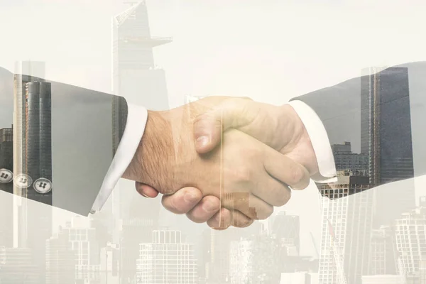 Double exposure handshake of two businessmen on office buildings background, collaboration and cooperation concept — Stock Photo, Image