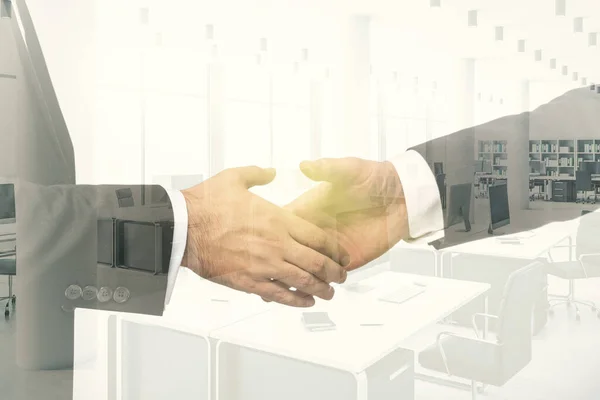 Handshake of two businessmen on modern furnished office interior background, deal and partnership concept. Multiexposure — Stock Photo, Image