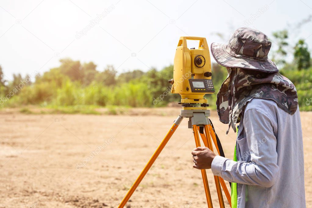 Land checking : Surveyor engineer making measure at the land