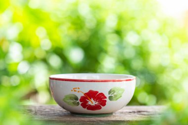 Beyaz boş seramik kase yeşil bulanıklık açık renkli ahşap tablo kapatın. Fotoğraf montajı için