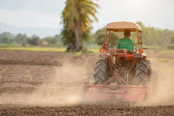 Thai farmer on big tractor in the land to prepare the soil for r — Stock Photo, Image