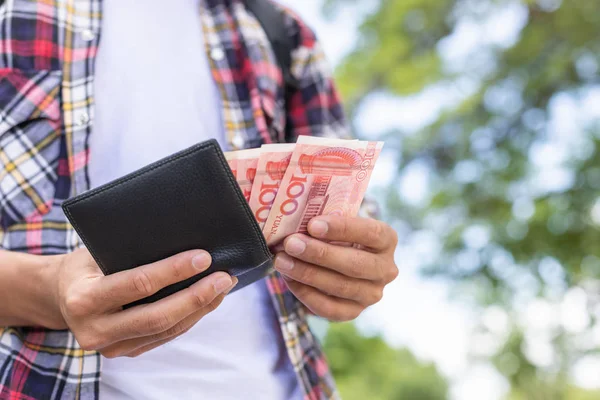 Tourist counting or checking banknote in black wallet that he fo — Stock Photo, Image