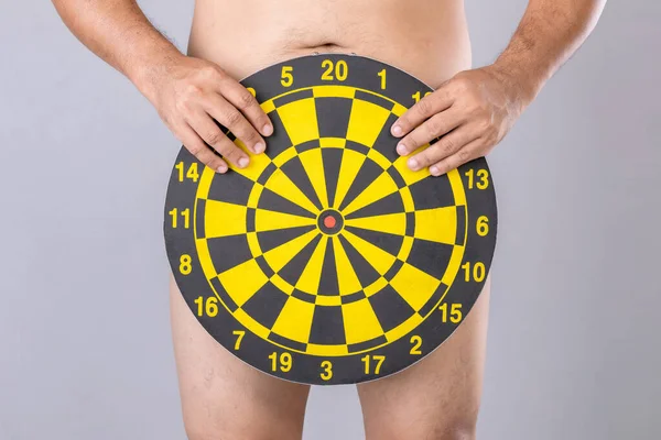 Man Holding Yellow Dartboard Hide His Penis Position Studio Shot — Fotografia de Stock