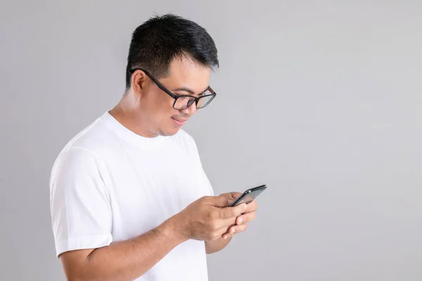 Hombre Asiático Escribiendo Charlando Estudio Teléfonos Inteligentes Tiro Sobre Fondo — Foto de Stock