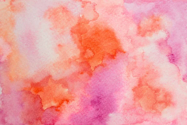 Hand painted watercolor. Abstract pink and orange watercolor on paper background.