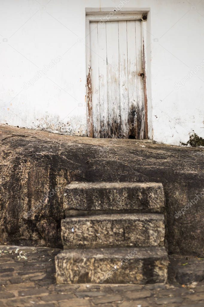 Image of old white wooden door and staircase at Sri Lanka.