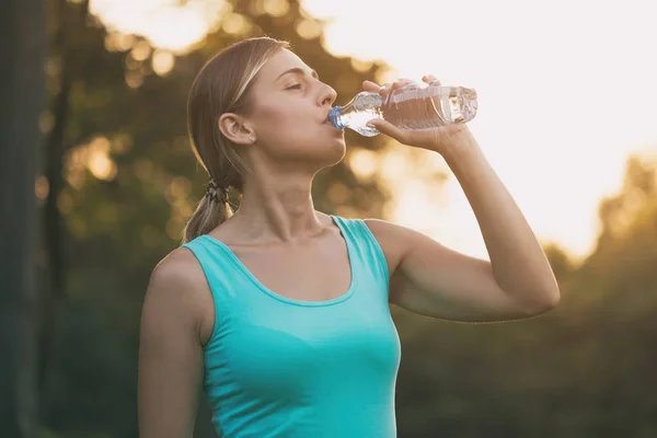 美しい女性は 運動中に水を飲むを楽しんでいます 画像は意図的にトーンダウンです — ストック写真