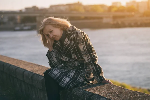 Senior Woman Having Headache While Sitting River Toned Image — Stock Photo, Image