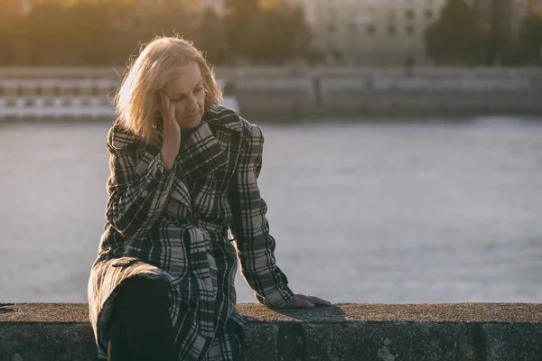 Senior Woman Having Headache While Sitting River Toned Image — Stock Photo, Image