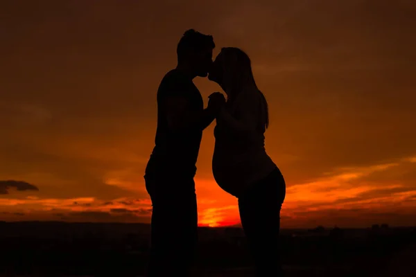 Silhuetas Marido Mulher Grávida Beijando Enquanto Eles Gostam Passar Tempo — Fotografia de Stock