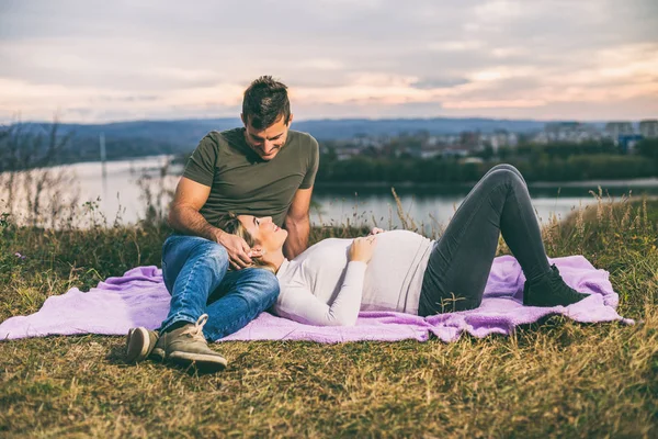 夫と妊娠中の妻と一緒に過ごす時間を楽しむ屋外 トーンのイメージ — ストック写真