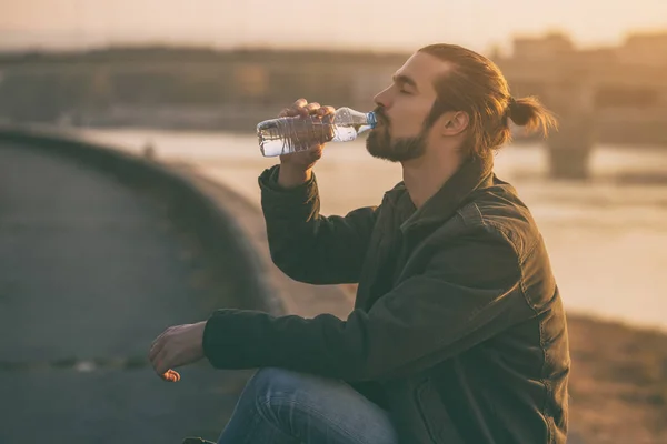 Handsome Modern Businessman Enjoys Drinking Water Resting River Toned Image — Stock Photo, Image