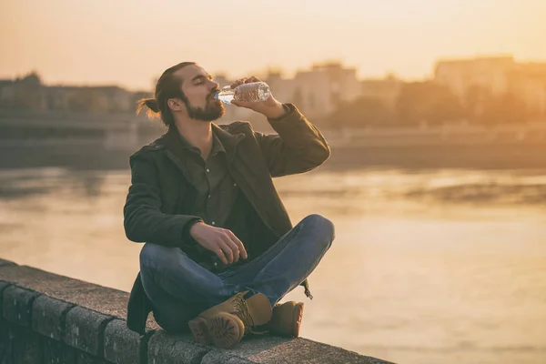 Handsome Modern Businessman Enjoys Drinking Water Resting River Toned Image — Stock Photo, Image