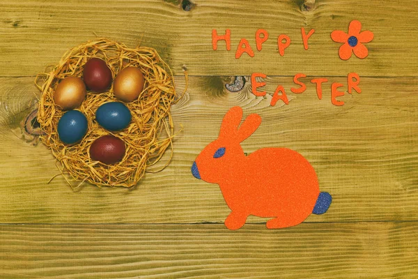 Happy Easter Message Painted Eggs Straw Bunny Flower Wooden Table — Stock Photo, Image