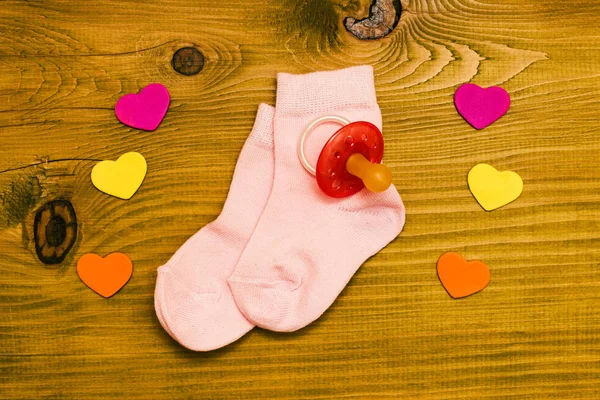 Little Pink Baby Girl Socks Pacifier Heart Shapes Wooden Table — Stock Photo, Image