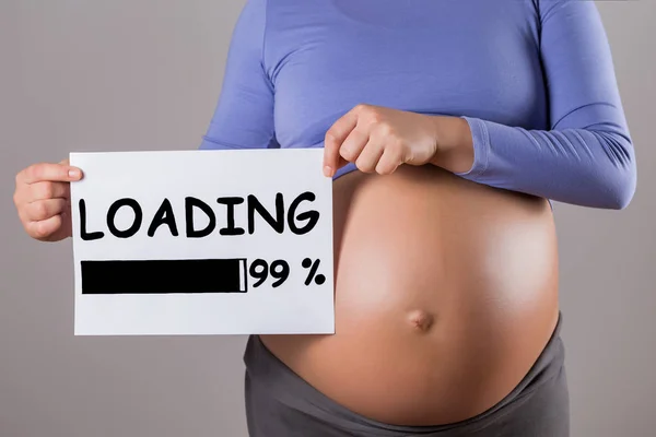 Image Close Stomach Pregnant Woman Holding Paper Text Loading Gray — Stock Photo, Image