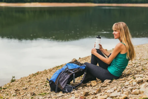 Donna Escursionista Bere Acqua Mentre Seduto Vicino Lago — Foto Stock