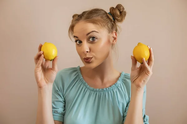 可爱的金发女人拿着柠檬的画像 — 图库照片
