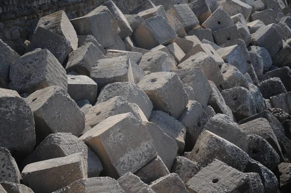 Concrete cube forms interlocked to make a sea wall breakwater