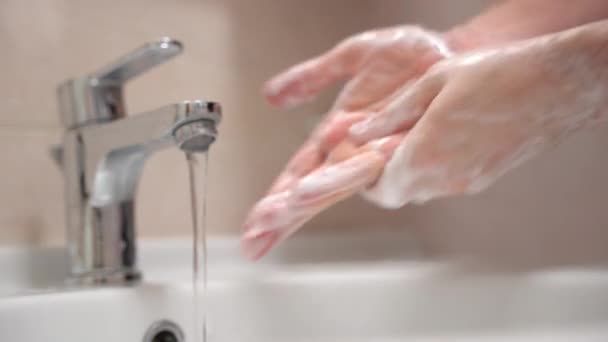 Acqua calda che scorre dal rubinetto e persona lavarsi accuratamente le mani con sapone schiumogeno, rimuovere sporco, microbo e batteri. Igiene obbligatoria quotidiana di ogni persona, cura della pelle e benessere — Video Stock