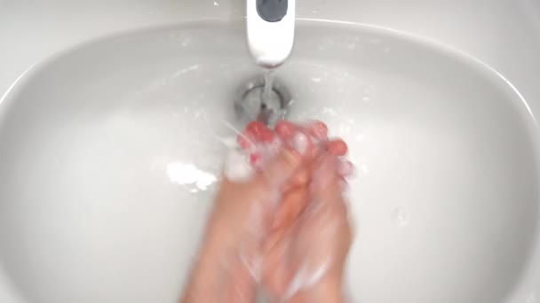 Coronavirus spreading prevention, male washing hands under warm water, using antibacterial soap, lathering hands and carefully rinsing. Cleaning hands frequently or after being in contact with other — Stock Video