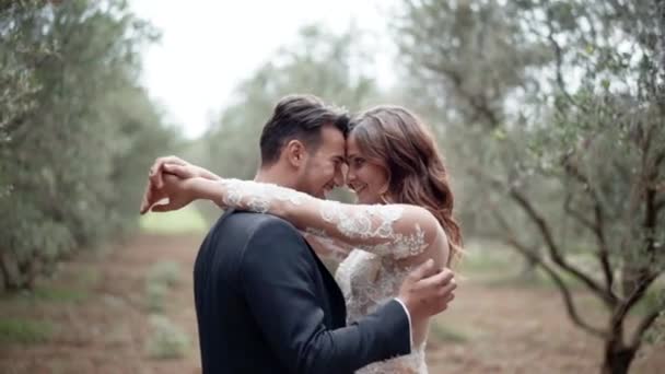 Joven pareja casada disfrutando de la presencia del otro en el jardín, increíble marco cinematográfico de recién casados con besos y abrazos íntimos. El afecto de la primera vista, el comienzo de una nueva familia — Vídeos de Stock