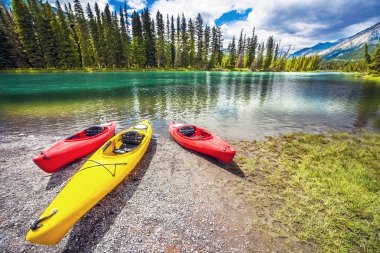Canoes at the Bow River in Banff National Park Alberta Canada clipart
