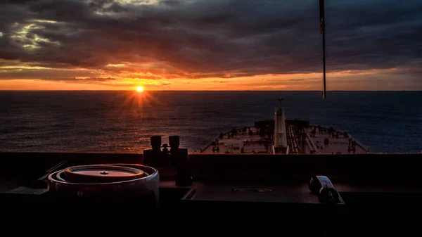 Sunset view from navigation bridge window of super tanker