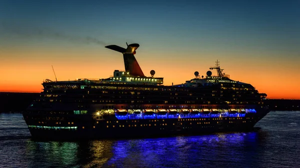 Passenger cruise vessel on sunset landscape
