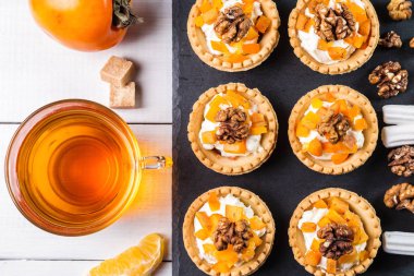Lor krem, Trabzon hurması ve şeffaf bir fincan çay ile Tartlets.