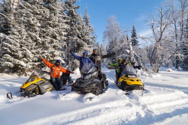 Snowmobile walking in the mountains of the southern Urals. clipart