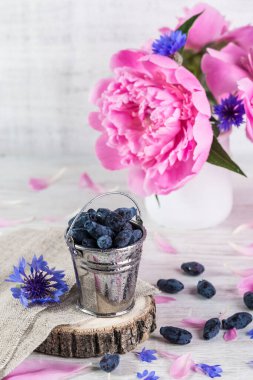 Hanımeli böğürtlenleri masasında küçük bir kovada.