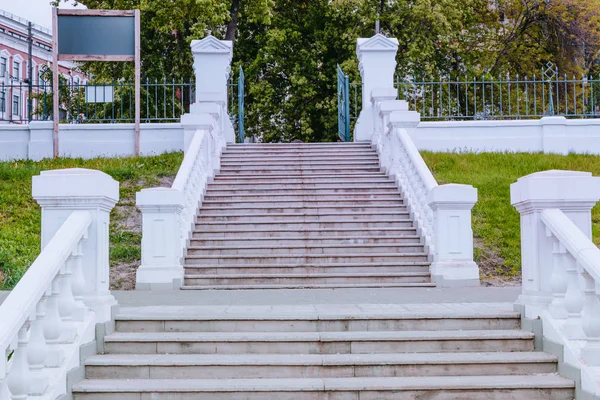 Stone staircase with white railing in the park
