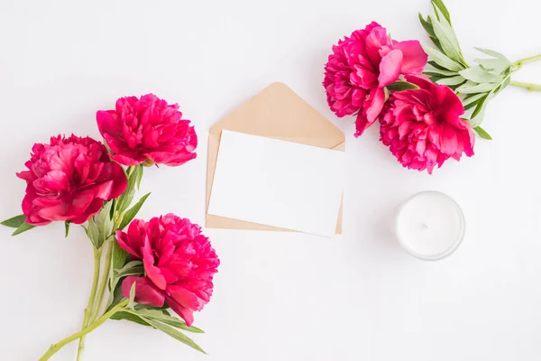 Mockup white greeting card and envelope with red peonies on a white background