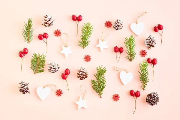 Flat lay christmas pattern with spruce branches and christmas decorations on a color background