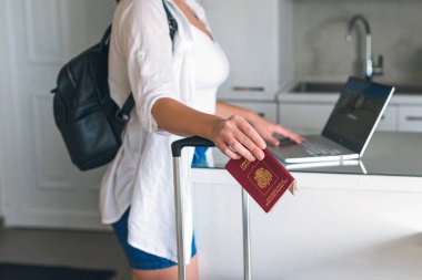 Kadın otel ve bilet rezervasyonunu dizüstü bilgisayarla yapıyor.