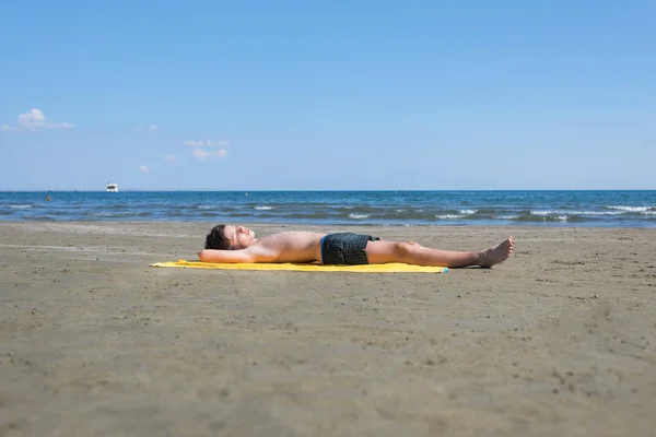 Teen Boy Lying Yellow Towel Sunbathes Beach — Stock Photo, Image