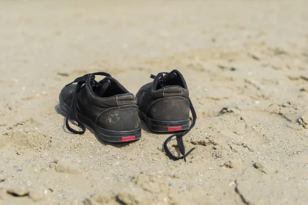 Black Sneakers Sandy Beach Sea Background Summer Travel Concept Royalty Free Stock Photos