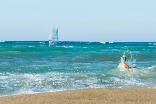 13 years old boy swimming and relaxation in the sea waves. Concept of family summer vacation