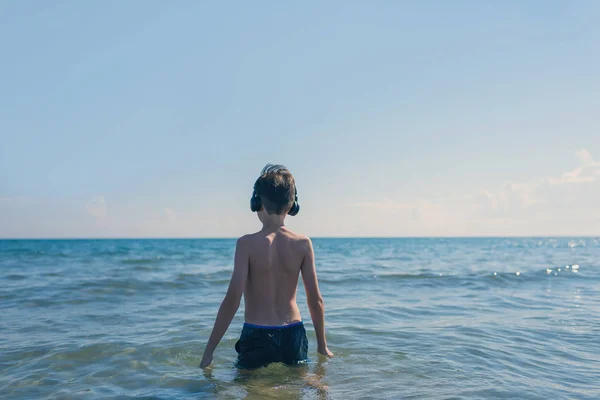 Teen Boy Słuchawkach Plaży Podróżowanie Dzieckiem Koncepcja — Zdjęcie stockowe