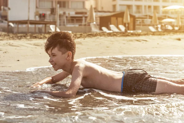 Felice Adolescente Ragazzo Diverte Sdraiato Sulla Sabbia Spiaggia Tramonto — Foto Stock