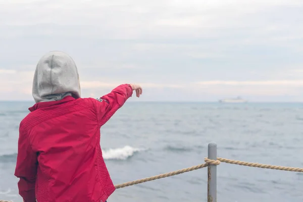 Boy Red Jacket Headphones Looks Sea Waves Stormy Rainy Weather — Stock Photo, Image