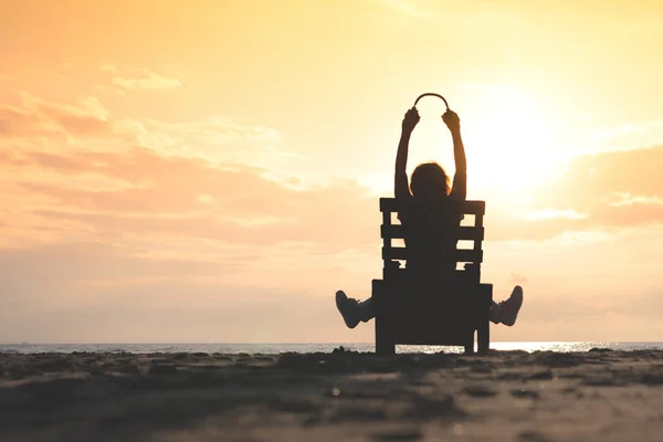 Chica Con Auriculares Está Sentado Tumbona Escuchando Música Playa Atardecer —  Fotos de Stock