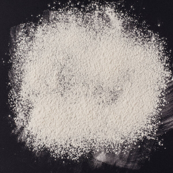 Background of wheat flour on a black background