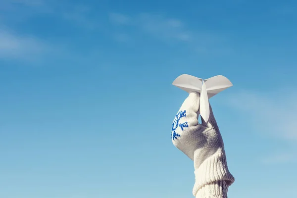 Girl Winter Knitted Mittens Launching Paper Airplane Blue Sky Background — Stock Photo, Image