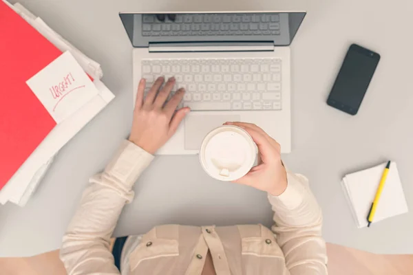 사무실에서 노트북을 작업하는 비즈니스 여성은 컵에서 커피를 마십니다 — 스톡 사진